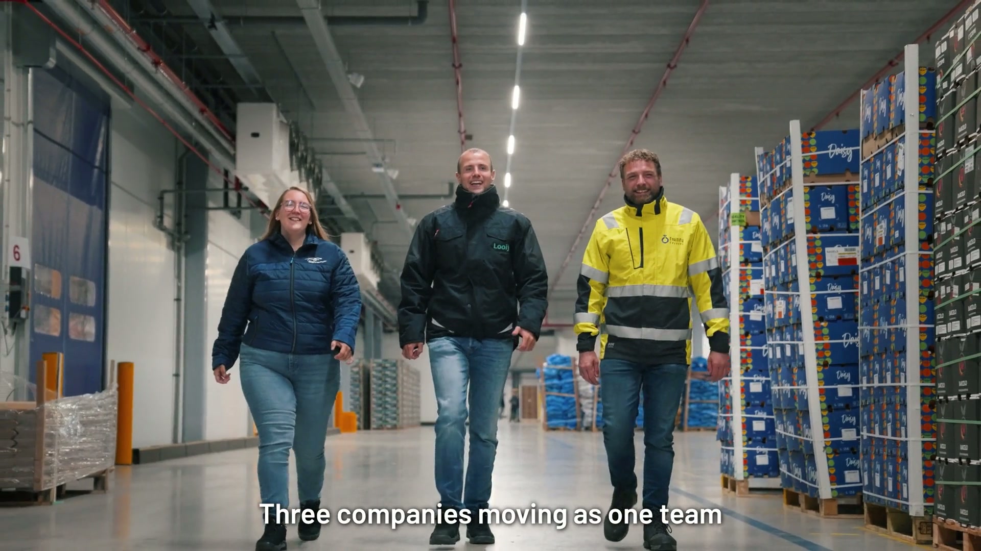 Three colleagues walking through the warehouse together